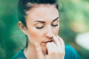 A woman practicing pranayama to focus herself.