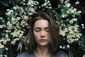 A woman asleep in a bundle of flowers.