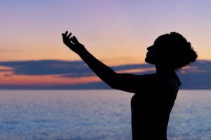 A woman practicing Reiki for wellness.